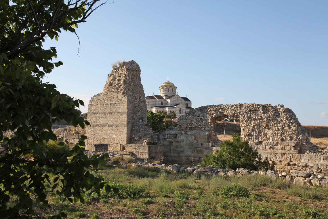some archaeological remains of the ancient Greek city of Khersonesos and in the distance the new Cathedral of Saint Volodymyr of Corson – Корсунь