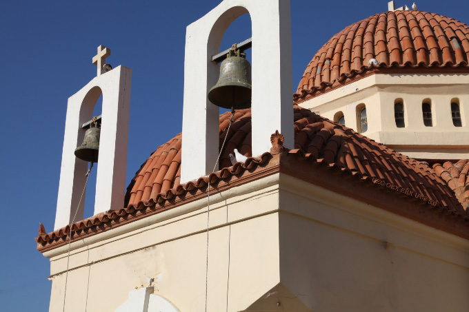 Church bells and doves by sea in Rethymno